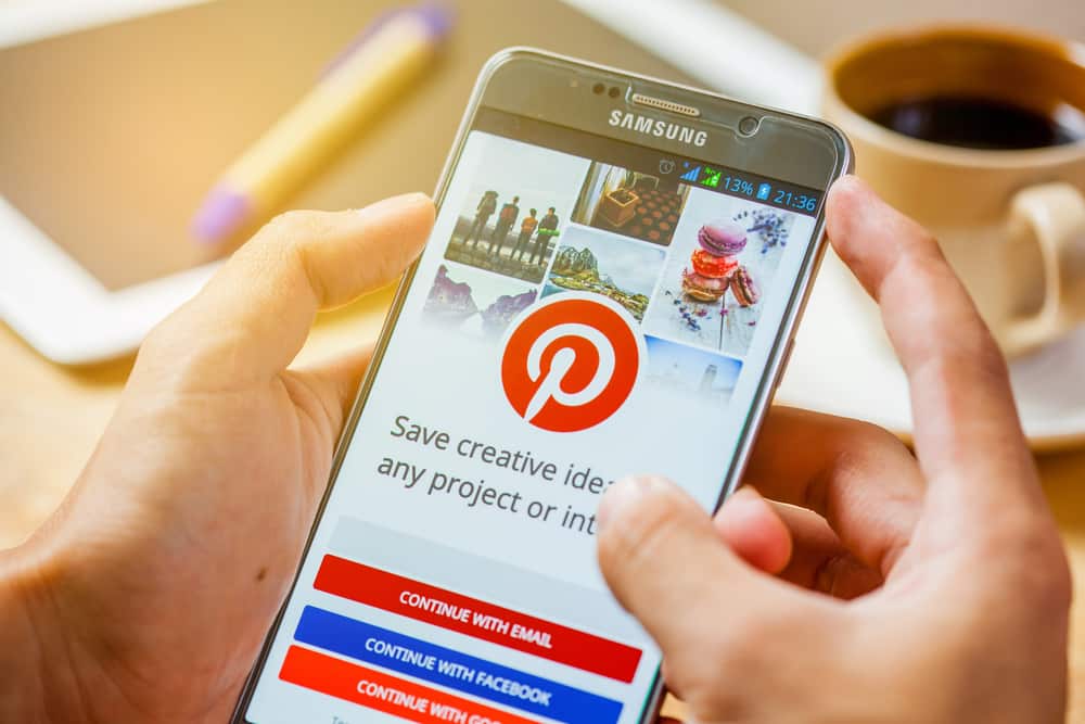 hands holding a Samsung Mobile with Pinterest on the screen